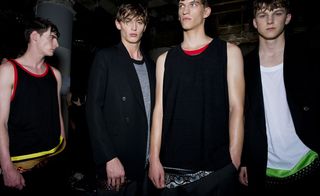 Males models wearing black, grey and white vests with bright trims from the Cerruti 1881 SS2015 collection