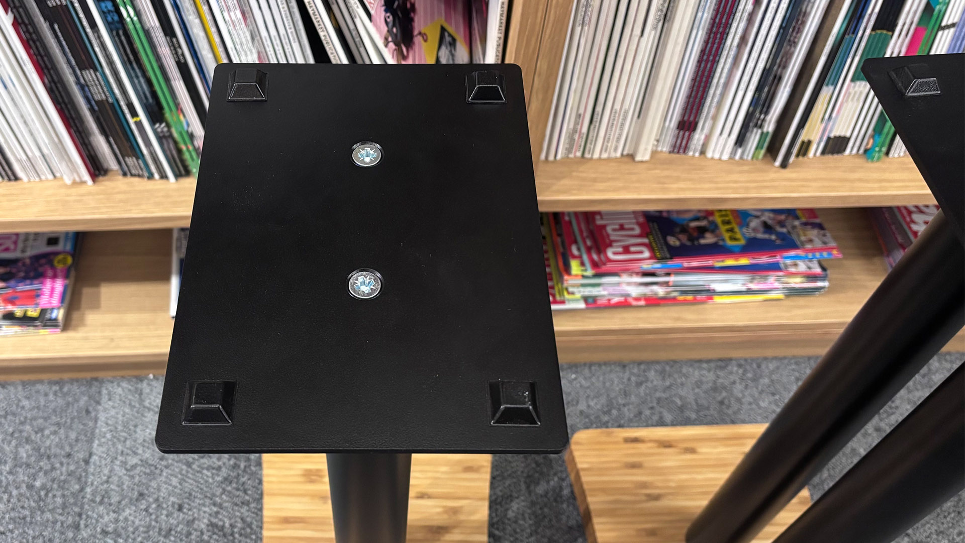 Atacama Moseco 6.2 speaker stands on grey carpet in front of bookcase