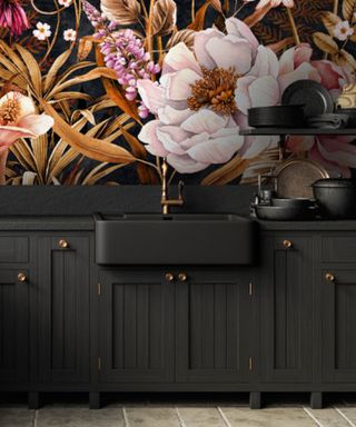 A maximalist bathroom with black cabinetry and floral wallpaper