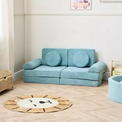 Tutti Bambini Montessori Kids Play Sofa in Ocean Stone in a kids' room with a lion head-shaped rug