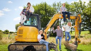 Sarah and her family sitting on a digger in Sarah Beeny’s New Life in the Country season 3