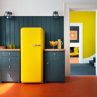kitchen room with yellow fridge and glass bowl with fruits