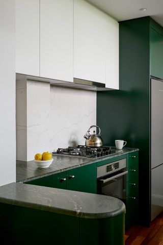 green kitchen with plinth island