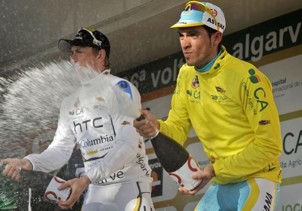 Andre Greipel and Alberto Contador partake in the champagne shower.