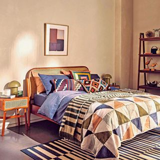 Netural bedroom with bold aztec patterned bedding