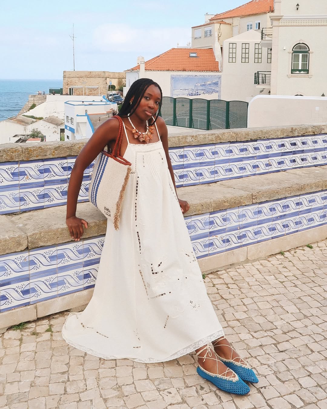 Raquel Costa Gomes wears white sun dress blue shoes