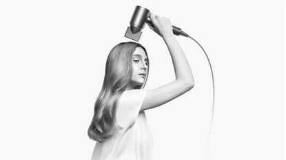 Woman using dyson supersonic hairdryer