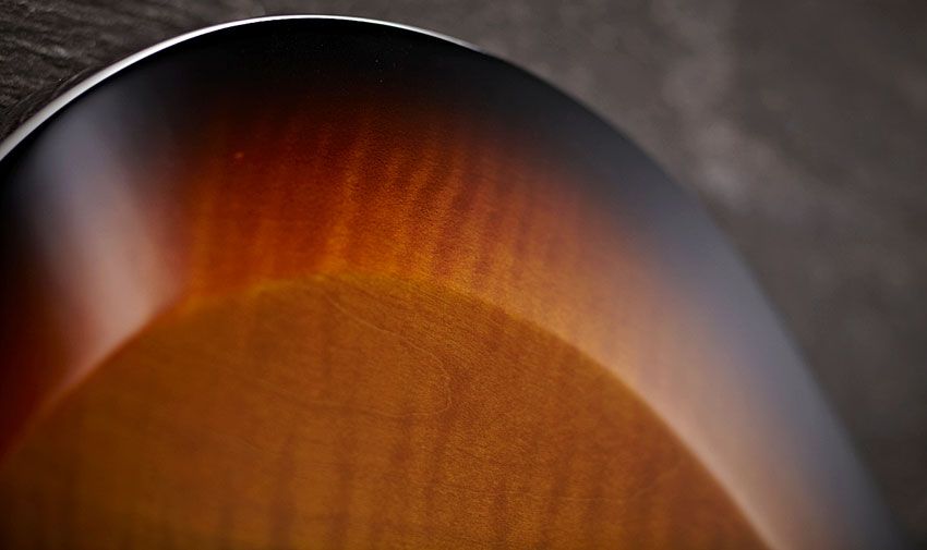 Unlike the more complex 'dished' carve of the Core-line PRS guitar tops, here, we have a flat top and a more SG-like bevelled edge