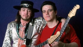 American singer, songwriter and Texas blues guitar legend Stevie Ray Vaughan and his brother, American blues-rock guitarist, singer and founder of The Fabulous Thunderbirds Jimmie Vaughan, pose backstage at the Royal Oak Music Theater during the "Soul to Soul" world tour, on February 14, 1986, in Royal Oak, Michigan.