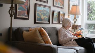 Elderly woman sits alone