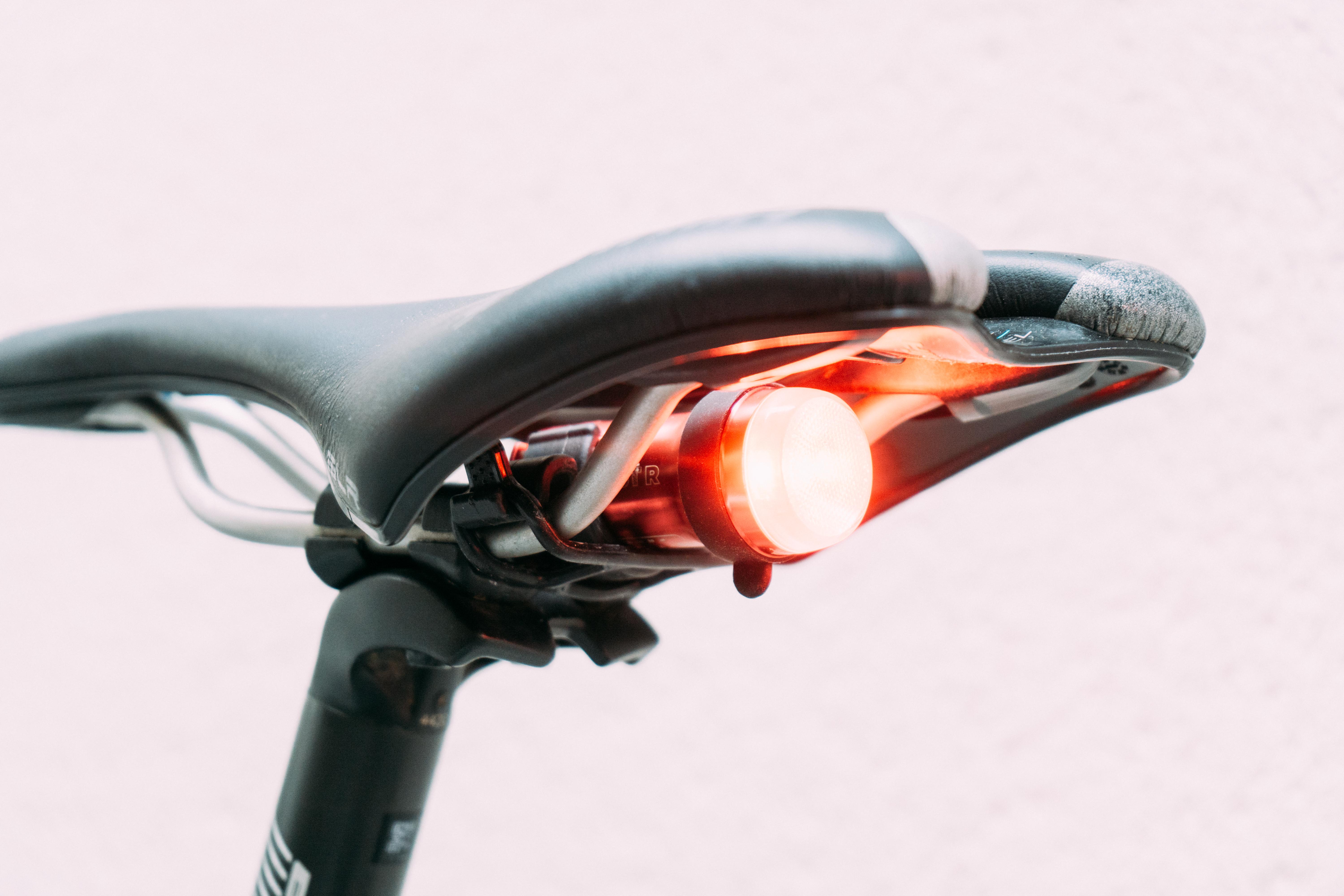 A red bike light mounted under a bike saddle