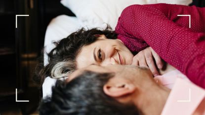 Woman and man lying next to each other on the bed, representing the best sex positions after menopause