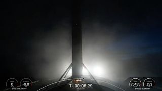 a rocket rests on the deck of a ship at night.