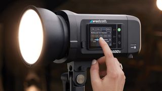 The Westcott FJ400 II with a person adjusting the settings on the touchscreen