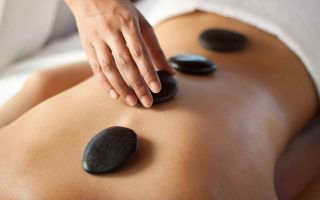 Woman with hot stones on back