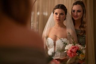 Catherine Missal as Grace, wearing a wedding dress and looking into the mirror as Grace Van Patten as Lucy looks over her shoulder, in Season 2 of Tell Me Lies.