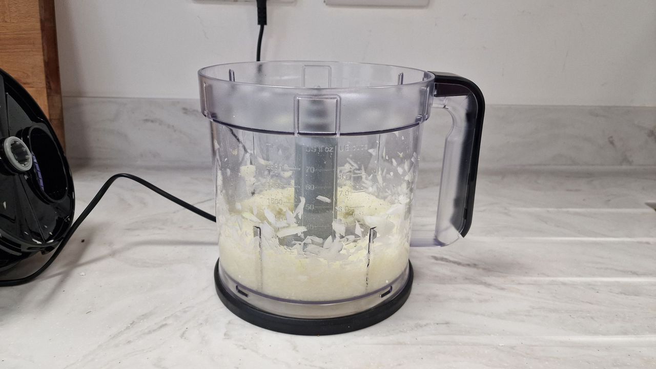Pureed onions in the bottom of a food processor jug.