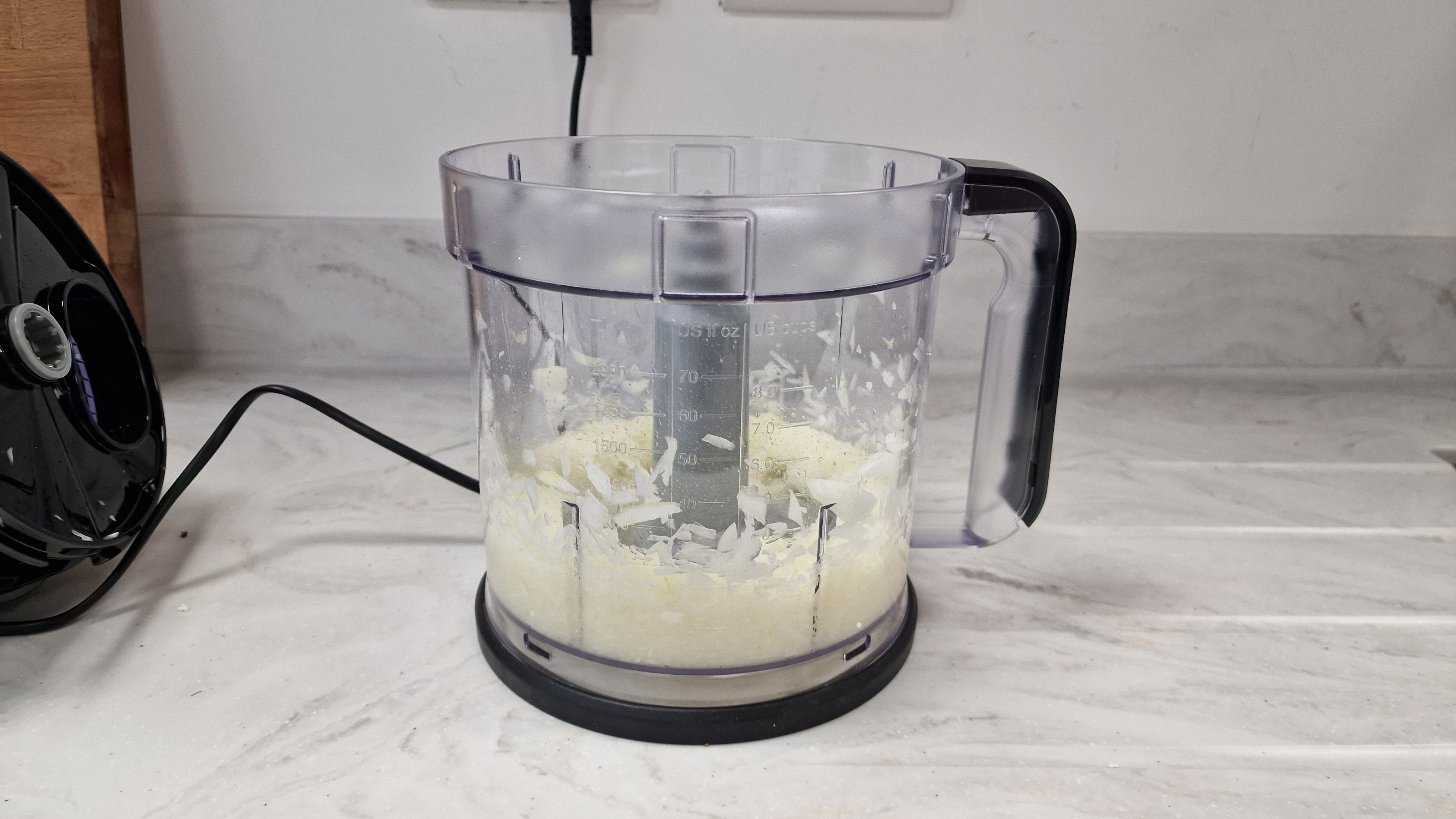 Pureed onions in the bottom of a food processor jug.