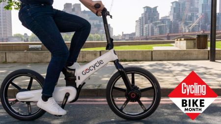 Image shows person riding an electric folding bike