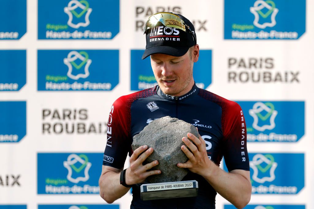 ROUBAIX FRANCE APRIL 17 Dylan Van Baarle of Netherlands and Team INEOS Grenadiers celebrates winning the race and holds up the Cobbleston trophy with his Oakley sunglasses on the podium ceremony after the 119th ParisRoubaix 2022 Mens Elite a 2572km one day race from Compigne to Roubaix ParisRoubaix WorldTour on April 17 2022 in Roubaix France Photo by Bas CzerwinskiGetty Images