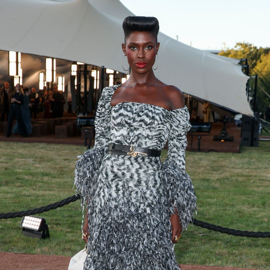 Jodie Turner Smith wearing an off-the-shoulder dress, red lipstick, and an updo