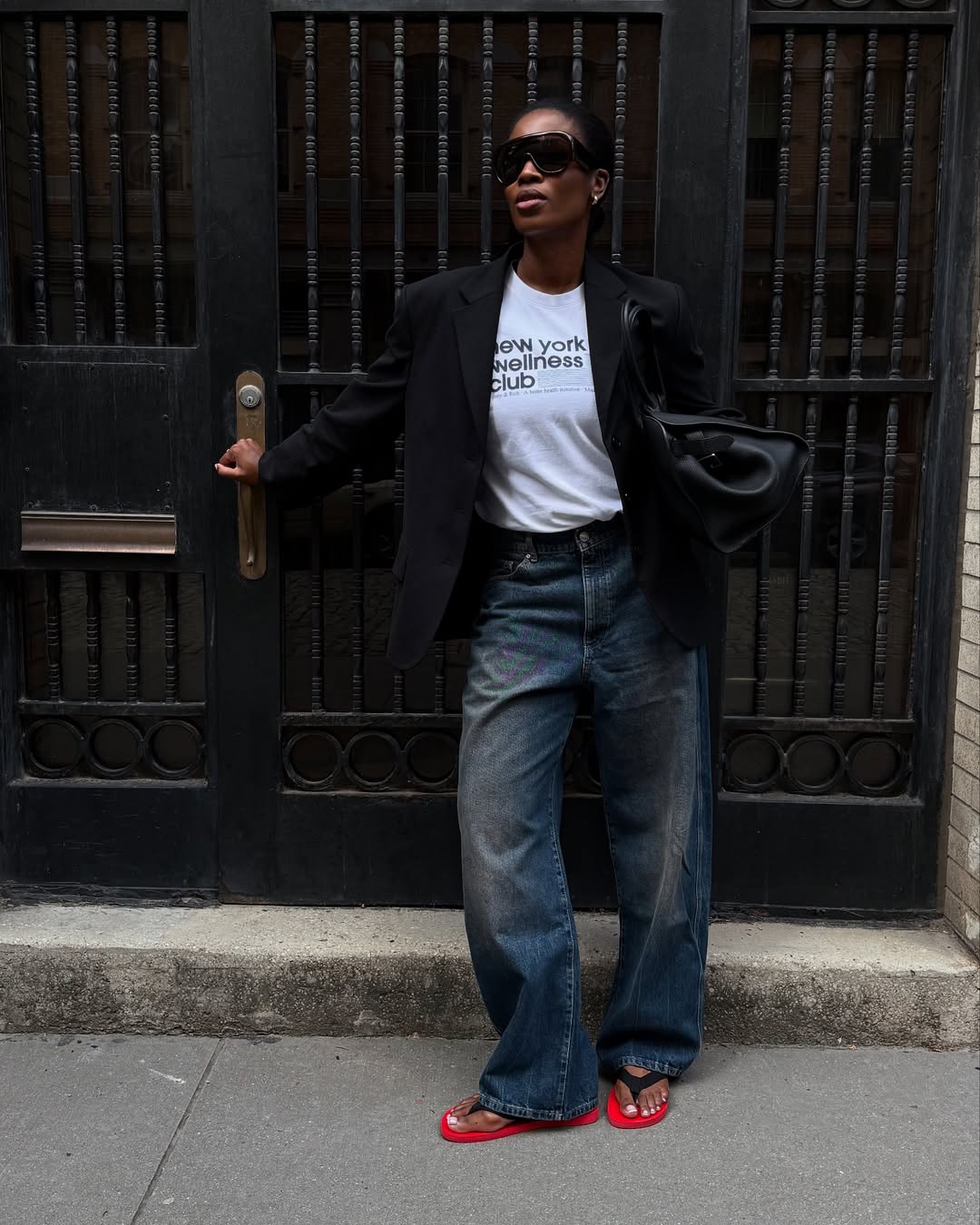 @nlmarilyn wearing bootcut jeans and flip-flops