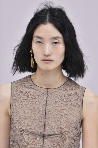 Model at Fendi wearing bed-head hair, a key Spring/Summer 2025 fashion month beauty look