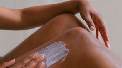 person applying lotion to legs