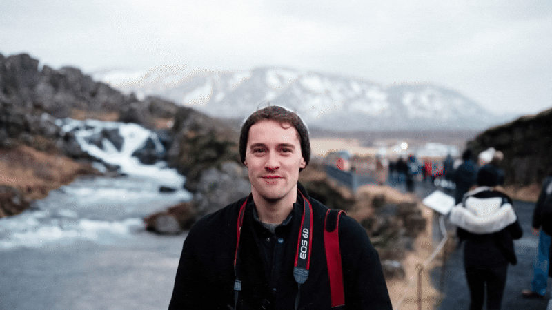 Motion gif of person standing in front of a waterfall talking