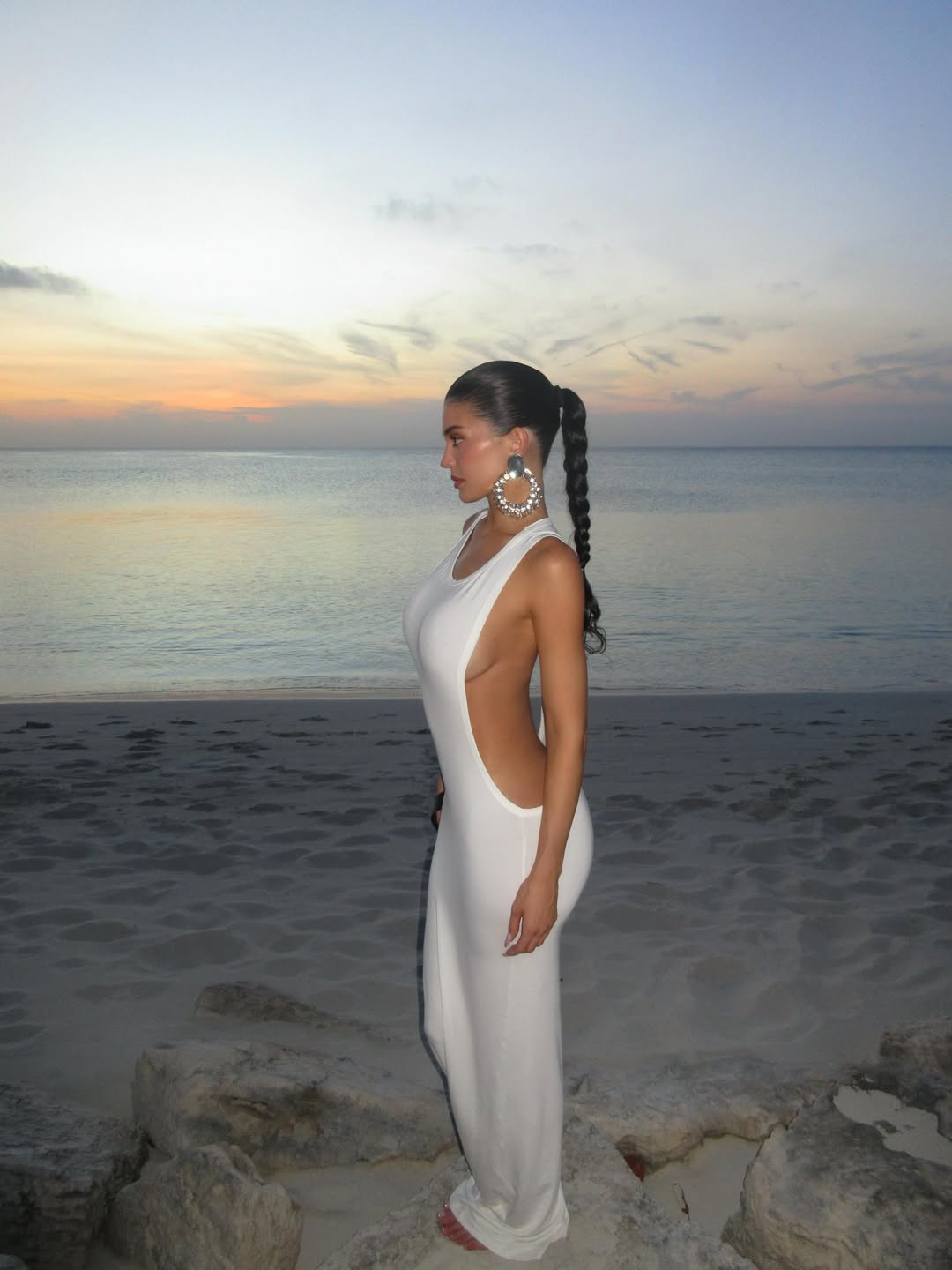 Kylie Jenner wore a little white Jacquemus dress with deep side cut-outs on vacation