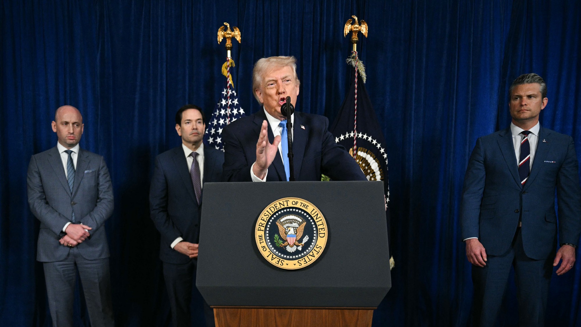 Donald Trump, alongside (L/R) Deputy Chief of Staff Stephen Miller, Secretary of State Marco Rubio, and US Secretary of Defense Pete Hegseth, speaks to the press following US military actions in Venezuela