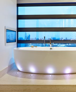 Contemporary bathroom with waterproof TV mounted onto the wall