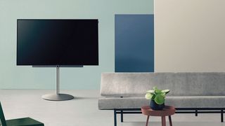 Loewe TV on stand, next to sofa