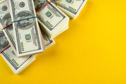 pile of bills on a yellow background