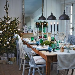 dining room with dining table with chairs and christmas tree