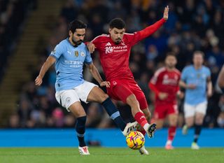 MANCHESTER, ENGLAND - DECEMBER 4: Ilkay Gundogan of Manchester City and Morgan Gibbs-White of Nottingham Forest in action during the Premier League match between Manchester City FC and Nottingham Forest FC at Etihad Stadium on December 04, 2024 in Manchester, England. (Photo by Visionhaus/Getty Images)