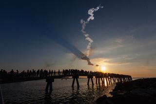 Onlookers at Cape Canaveral, Florida, watch NASA's test of the launch abort system of its Orion capsule on July 2, 2019.