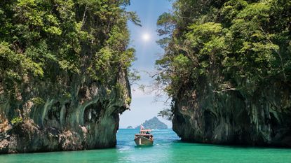 jk29wf beautiful landscape of rocks mountain and crystal clear sea with longtail boat at phuket, thailand summer, travel, vacation, holiday concept
