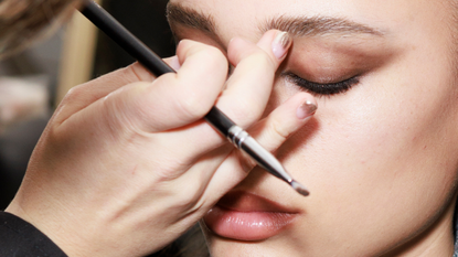 best eyeshadow primer - make-up artist applying eye make-up to a mode