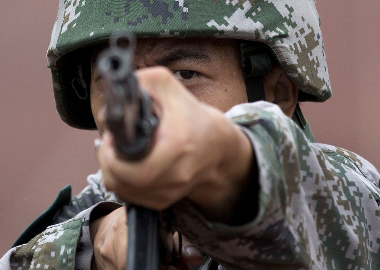 A cadet of Chinese People&amp;#039;s Liberation Army raises a bayonet at the PLA&amp;#039;s Armoured Forces Engineering Academy Base.