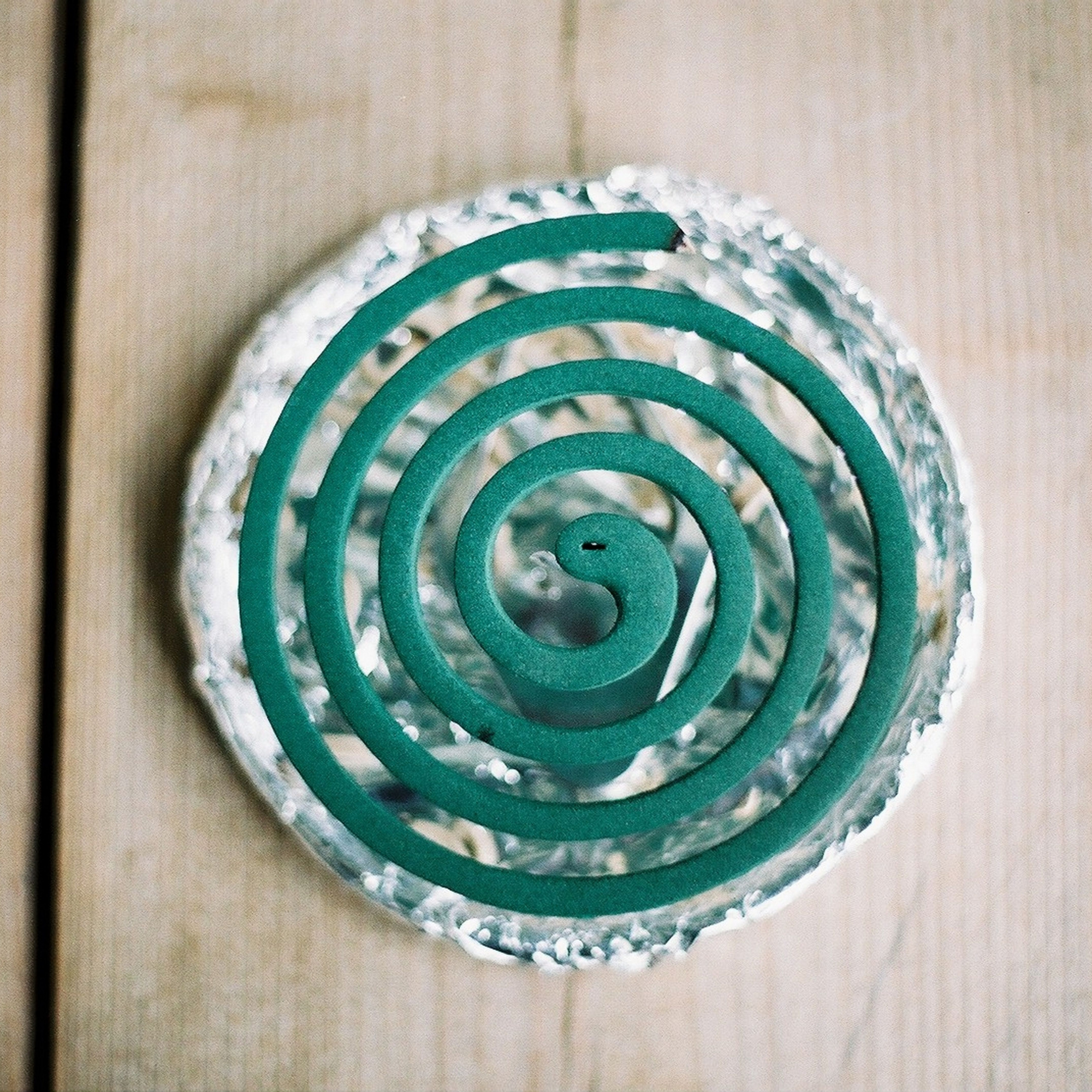 Green mosquito coil on a dish.