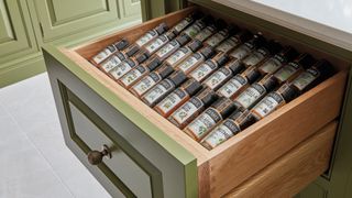 green kitchen with spice draw to demonstrate how to organise kitchen drawers in the style of a pantry