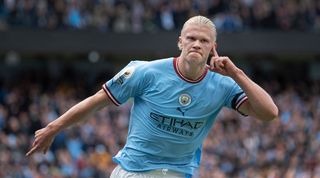 Erling Haaland celebrates one of his three goals for Manchester City against Manchester United.