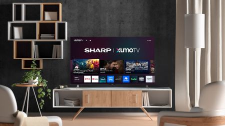 Sharp Aquos Xumo TV on stand in living room