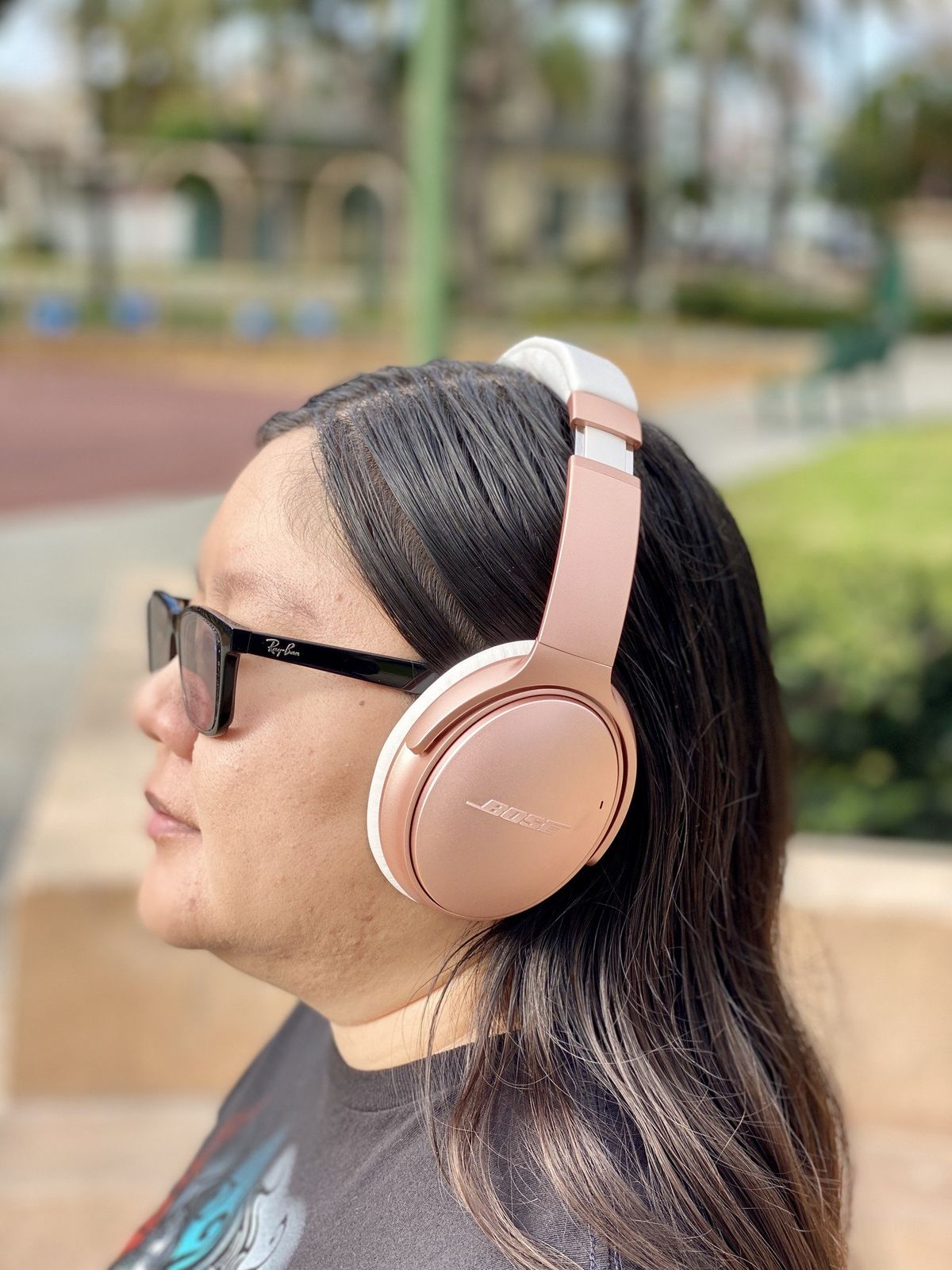 Christine wears her Rose Gold Bose QuietComfort 35 II headphones