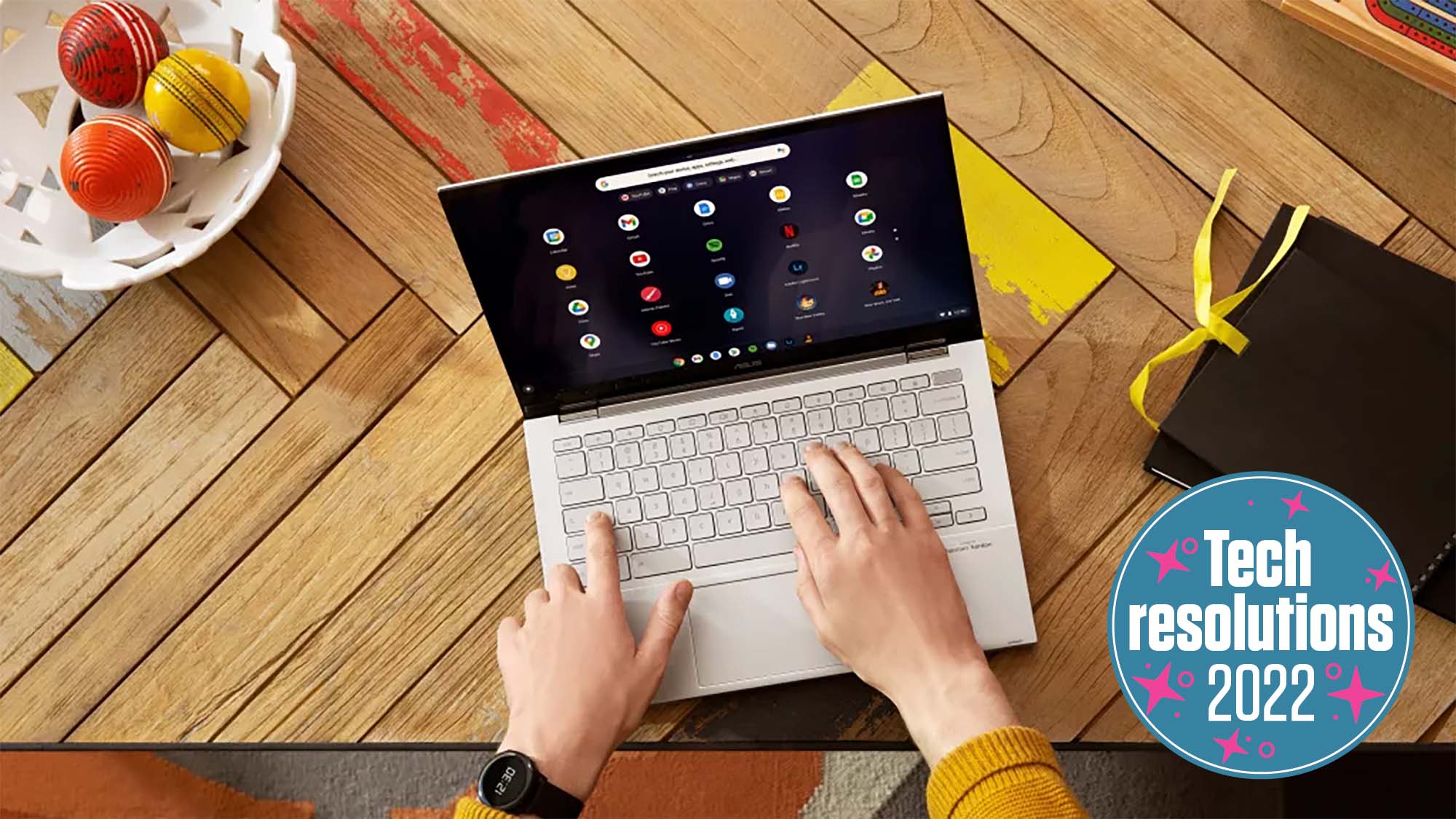 Someone using an Asus Chromebook with a TechRadar Tech Resolutions 2022 badge in the corner