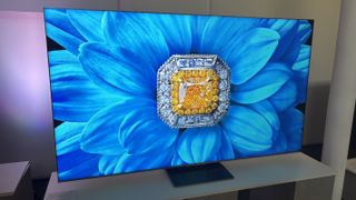 A flower on a TV screen with a gem in the middle.