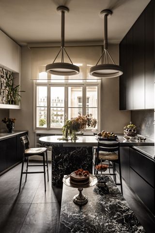 A dark and elegant kitchen with dark marble