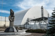 New Safe Confinement structure covers the original sarcophagus and radiation underneath it.