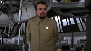 Michael Lonsdale stands in uniform in his lab in Moonraker.